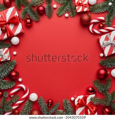 Red Christmas template for design with festive frame on red background. Flat lay, top view and copy space for text