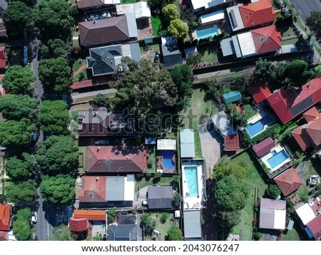 Panoramic Aerial Drone view of Suburban Sydney housing, roof tops, the streets and the parks NSW Australia