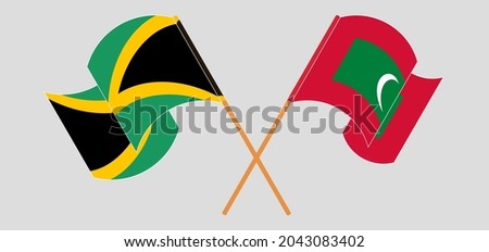 Crossed and waving flags of Jamaica and Maldives