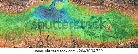 Earth surface in satellite photo. Aerial top view of green fields at river delta as panoramic abstract background. Nature, terrain, map and topography theme. Elements of this image furnished by NASA.