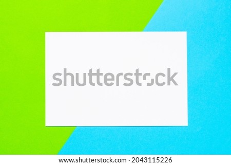 White blank sheet on a blue-green background. Advertising, layout, template, mockup.