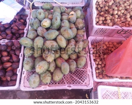 mangoes and other fruits that are being sold in the market