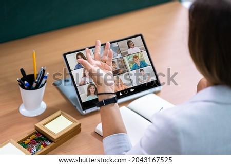 Teacher Hosting Online Class Using Video Conference On Laptop