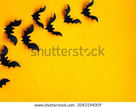 Halloween background. Bats on an orange background. Smooth layout.