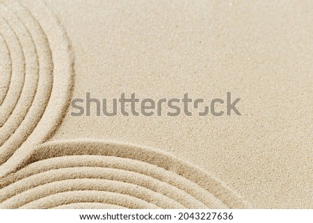 Pattern in Japanese Zen Garden with close up concentric circles on sand for meditation and tranquility. Aesthetic minimal sandy background. Selective focus.