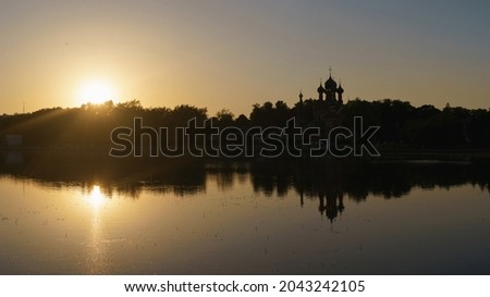 Back lit photography. Moscow calm cityscape. Church of the Life-Giving Trinity in Ostankino at the summer gold sunset time.