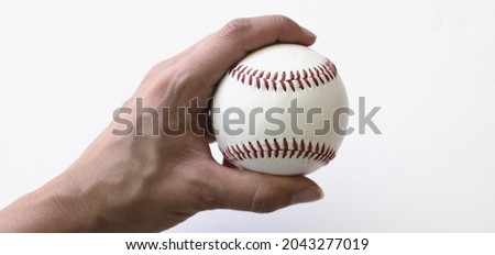 Hand holding baseball ball close up for sports game.