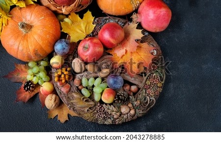 Wiccan altar for Mabon sabbat. fruits, pumpkins, leaves, nuts, wheel of the year on black background. pagan, Wiccan traditions. Witchcraft, esoteric spiritual ritual. autumn equinox holiday Royalty-Free Stock Photo #2043278885