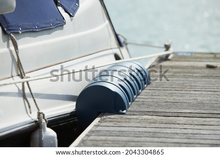 Long pier blue fenders for a boat and dockside for protection. Maritime fenders Royalty-Free Stock Photo #2043304865