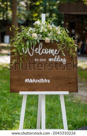 Wooden welcome table board sign at the wedding on the beach with welcoming romantic words during destination wedding marriage ceremony