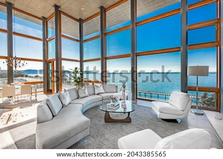 Urban condo with floor to ceiling windows and ocean view Royalty-Free Stock Photo #2043385565