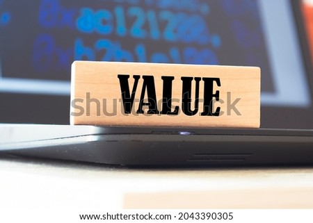 The word VALUE is written on wooden cubes near the handle