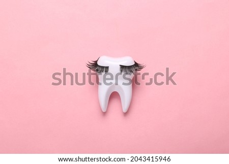 Tooth with eyelashes on pink background. Minimal concept art