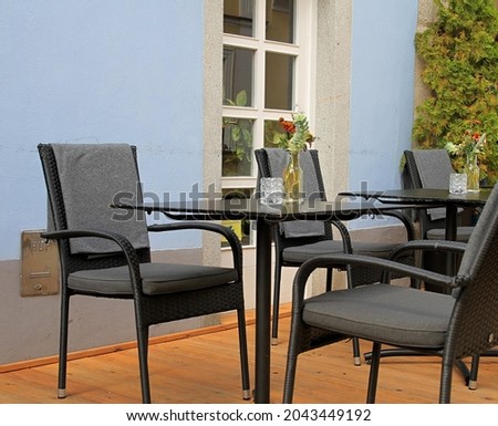 table with chairs outside a restaurant area in London no people stock photo
