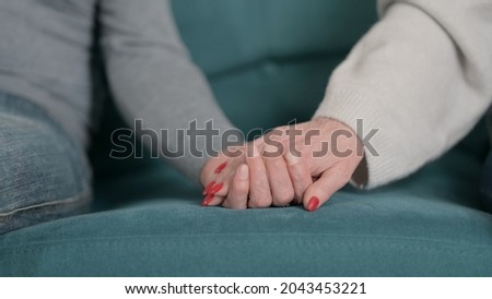 Close up of Old Man Putting Hand over Woman's Hand