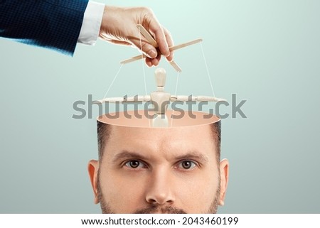 In the man's head, instead of a brain, a puppet is a doll. The concept of addiction, slave, controlled person, tedious employee, clerk, office plankton Royalty-Free Stock Photo #2043460199