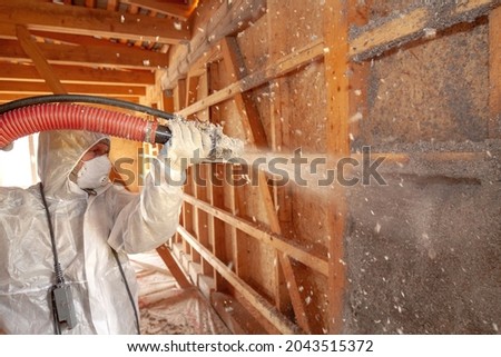 Spraying cellulose insulation on the wall Royalty-Free Stock Photo #2043515372
