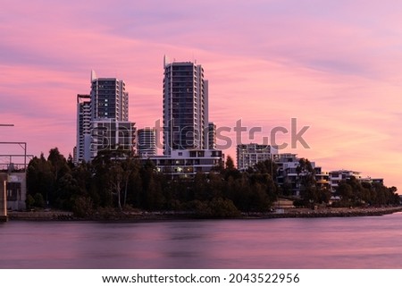 Sunset view over Rhodes building skyline, Sydney, Australia.