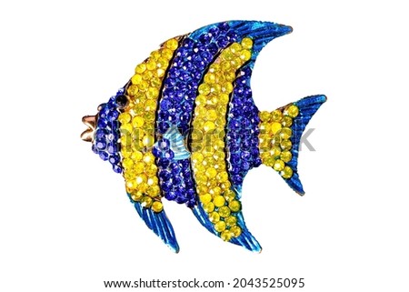 A fish jewelry on white background, isolated. Royalty-Free Stock Photo #2043525095