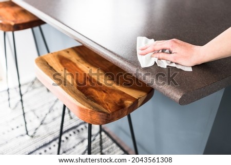 disinfecting surfaces from bacteria or viruses, hand cleaning bar table with disinfectant wet wipe cleanliness in your home or hospitality business Royalty-Free Stock Photo #2043561308
