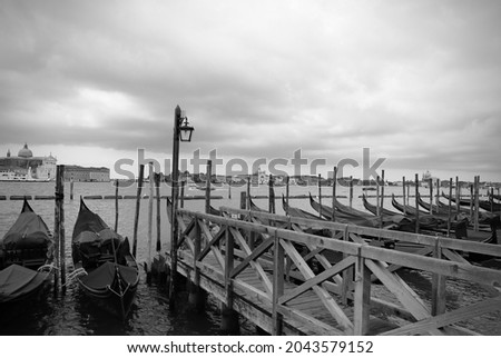Gondolas on pier in the Venetian Lagoon, Venice. 