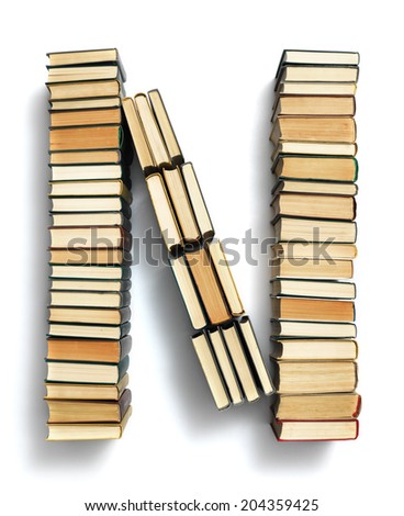 Letter N formed from the page ends of closed vintage hardcover books standing on a white background from a set or series of numbers