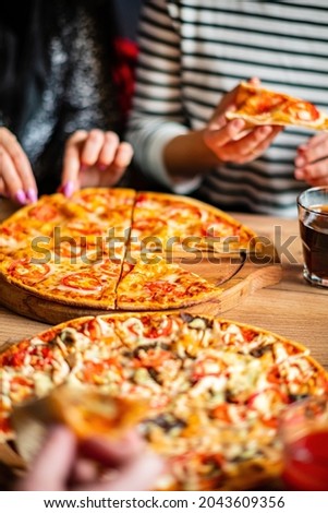 Group of people eating pizza. 