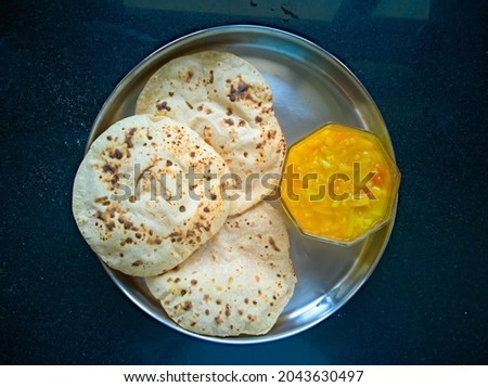 top view of three roti with sabjee on black background Royalty-Free Stock Photo #2043630497