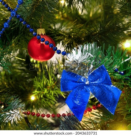 Christmas tree decorations with baubles and bows close up