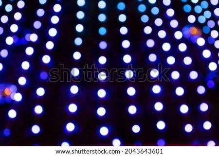 Christmas background, glowing multicolored neon lights. Copy space. Out of focus