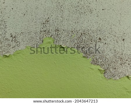 The wall with the paint peeled off.