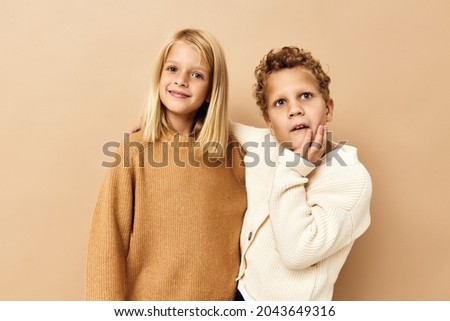  cute stylish kids hugs laughter friendship beige background