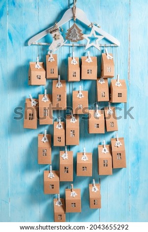 Original Christmas Advent Calendar as a countdown to Christmas on blue wooden background