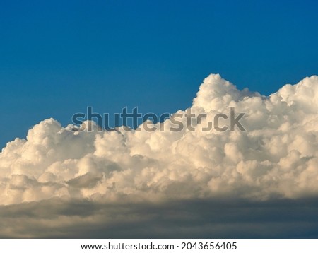 Dark and white clouds on a background of blue sky  