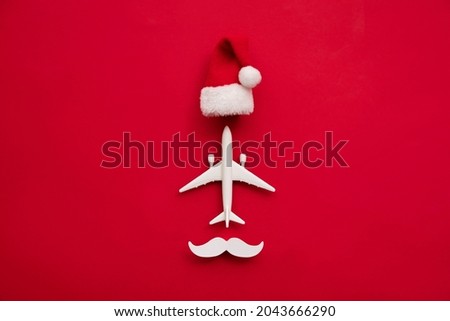 Festive christmas travel reindeer made from airplane and antlers on a red background
