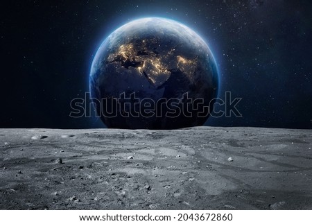 Moon surface and Earth at night in deep space. Planet and satellite. Artemis space program. Elements of this image furnished by NASA