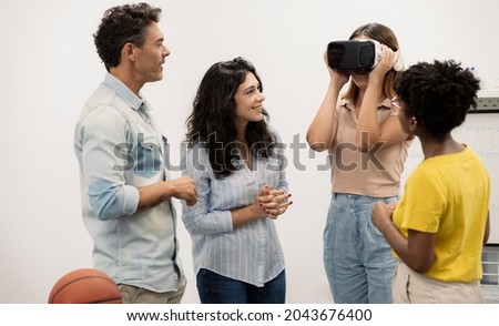group of people use virtual reality glasses in an office
