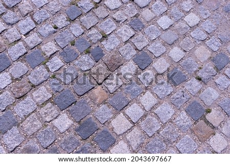 Abstract background. Old cobblestone pavement close-up. Selective focus