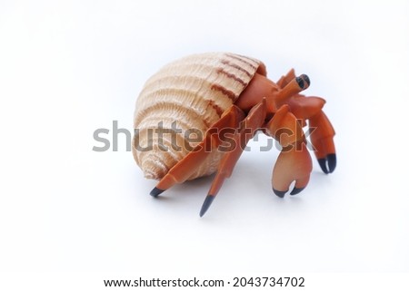Hermit crab toy on white background. Plastic hermit crab sea animal figure toy for kid