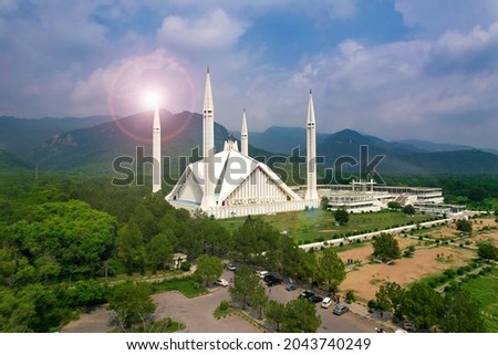 Aerial shot of Islamabad, the capital city of Pakistan showing the landmark Shah Faisal Mosque and the lush green mountains of Margala Hills Royalty-Free Stock Photo #2043740249