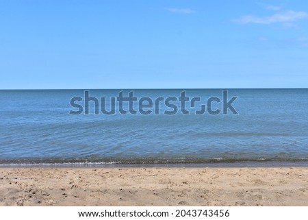 Lake Superior sandy beach under blue skies. Porcupine Mountains, Michigan.