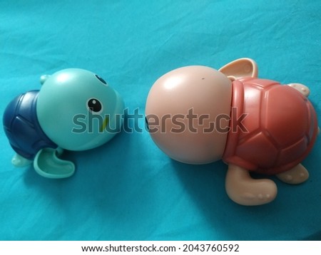 children's toy in the form of a turtle that can be used in water pools