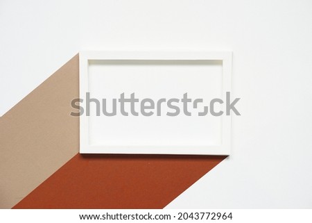 blank clean white horizontal paper frame with two colors of brown paper and beige paper against white paper background, top view, flat lay.