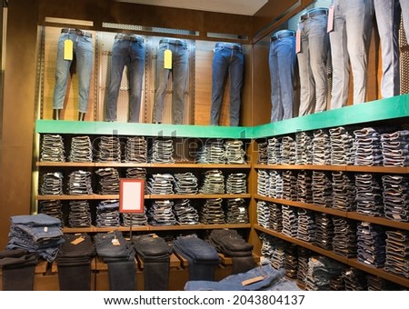 different jeans on mannequins in a clothing store