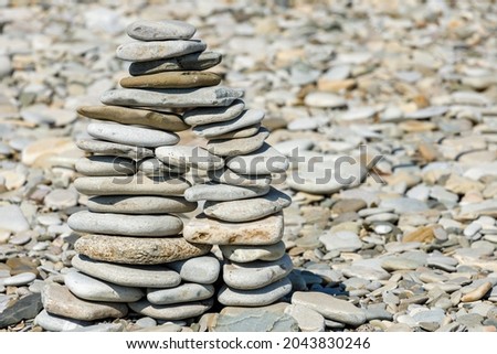 pyramid of sea stones on the beach in summer. High quality photo