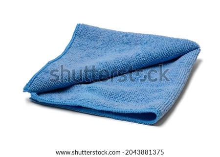 The towel is on a white background. This is isolated view of blue micro fiber kitchen napkin. Royalty-Free Stock Photo #2043881375
