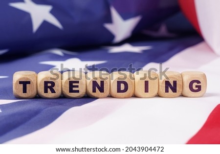 American economy and business concept. The US flag has cubes with the inscription - TRENDING