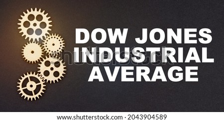 Business and industry concept. On a black background, gears and the inscription - Dow Jones Industrial Average Royalty-Free Stock Photo #2043904589