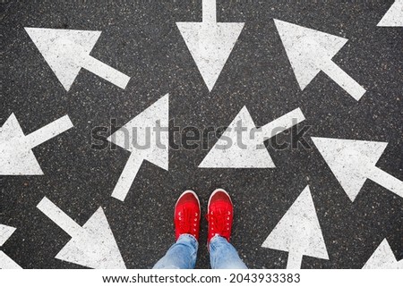 Person standing on the road to future life with many direction sign point in different ways. Decision making is very hard to design Royalty-Free Stock Photo #2043933383