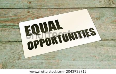 Equal opportunities words on card on wooden table. Business concept,